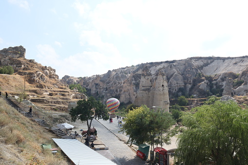 Tourist attraction destination of Goreme Cappadocia fairy chimneys, cave house and hot air baloon.