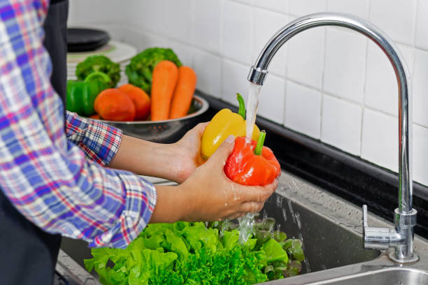 istock Washing vegetables in the kitchen sink 1555427362