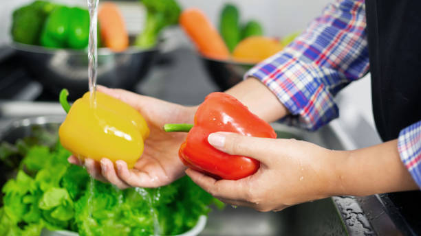 istock Washing vegetables in the kitchen sink 1555427368