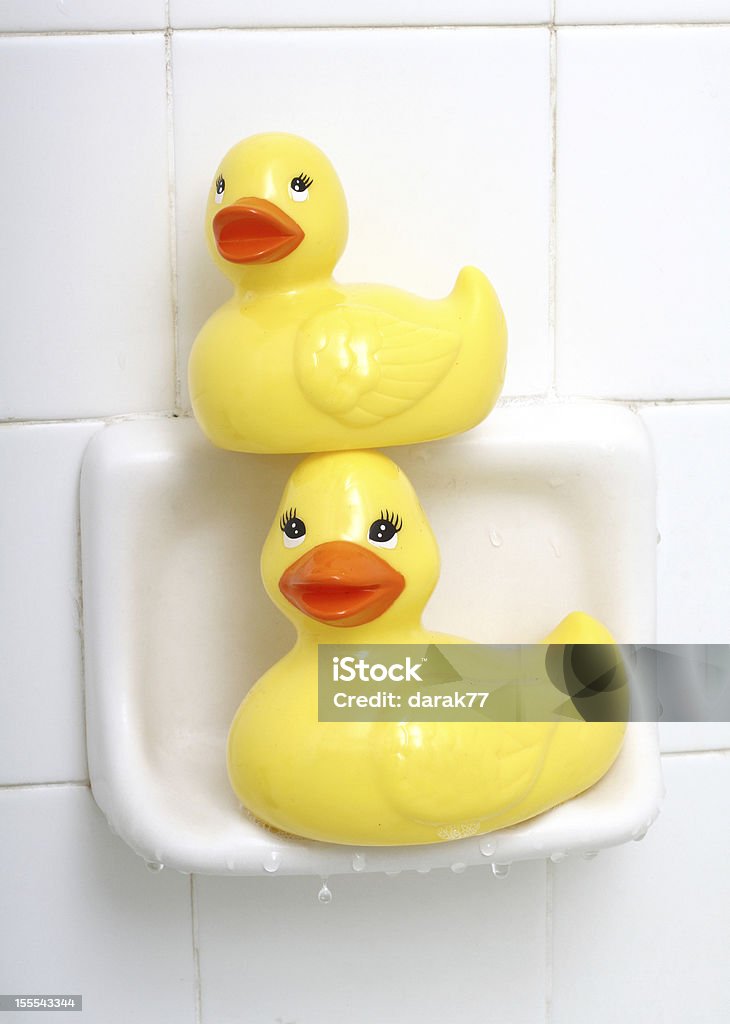 Rubber Duck Twins Two yellow rubber ducks sitting in a soap dish in the bath tub. Bathroom Stock Photo