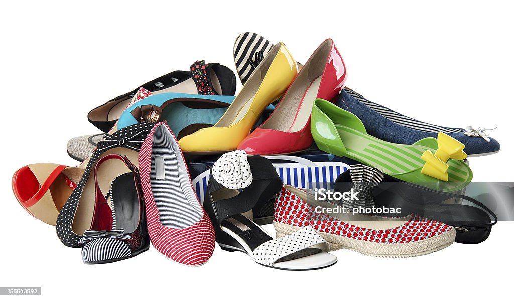 A pile of multi-colored and patterned women's shoes Pile of various female summer shoes isolated over white background, with clipping path Shoe Stock Photo