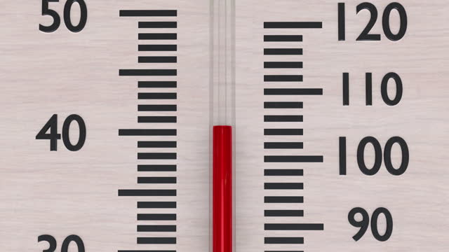 Macro shot of rising temperature in wooden thermometer.