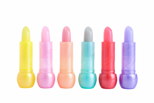 Children hygienic lipstick with different fragrances isolated on white background. Decorative cosmetics for lips.