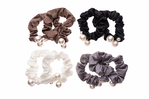 Set of hair ties with beads of different colors isolated on white background.