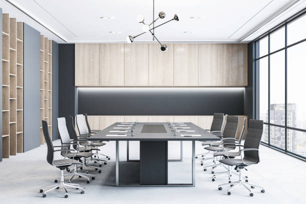 istock Front view of modern empty meeting room interior with office table and chairs, window, concrete floor and wooden walls. 3D Rendering 1555451540