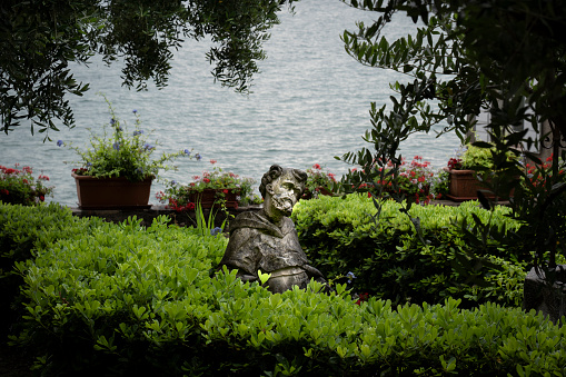 statue in a garden of sirmione on lake garda