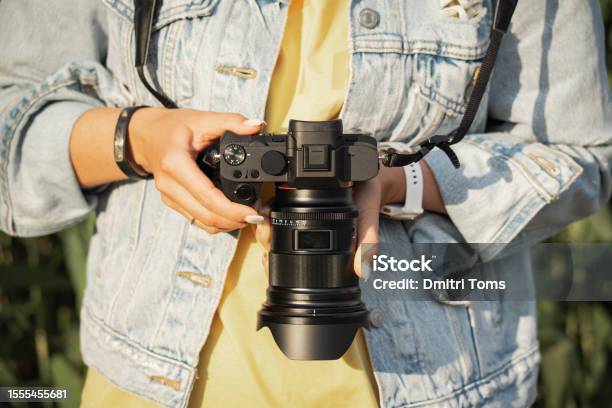 Digital Mirrorless Camera With A Lens In The Girls Hands Closeup Photo Stock Photo - Download Image Now