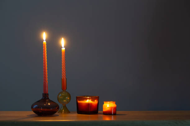 istock burning candles in glass candlesticks on dark background 1555455741