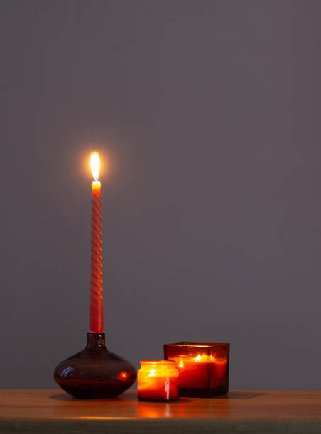 istock burning candles in glass candlesticks on dark background 1555455759