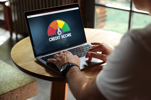 People Using Laptop and Credit Score Concept on Screen