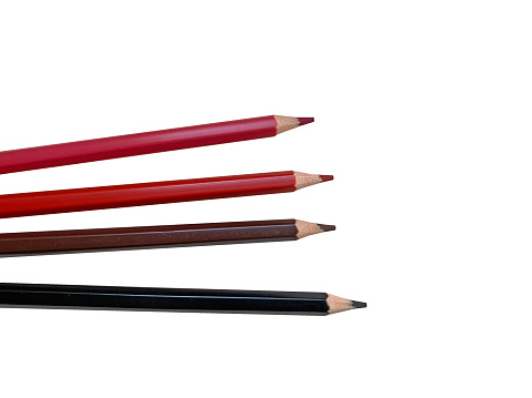 color pencils drawing scattered with white background. Pencils red, pink, black. Top view