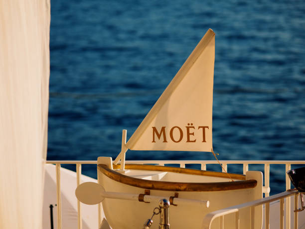 Moet et Chandon champagnes promotion on interior of luxury open-air restaurant on Adriatic sea coast. Valentino cocktail and champagne bar logos on white sun umbrellas. Rovinj, Croatia - July 7, 2023 Moet et Chandon champagnes promotion on interior of luxury open-air restaurant on Adriatic sea coast. Valentino cocktail and champagne bar logos on white sun umbrellas. Rovinj, Croatia - July 7, 2023 moet chandon stock pictures, royalty-free photos & images