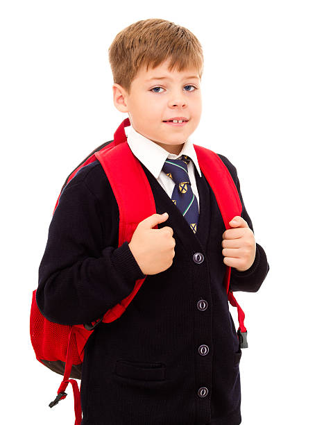 Schoolboy standing with his backpack. stock photo