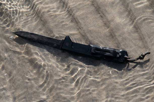 istock Pocket knife underwater on the beach 1555490063