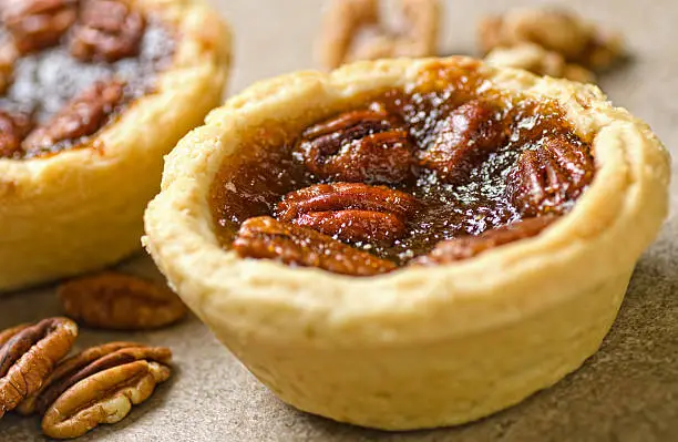 Photo of Close-up photograph of pecan tartlets and pecan nuts