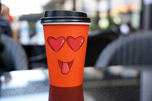 Emoji on paper coffee cup