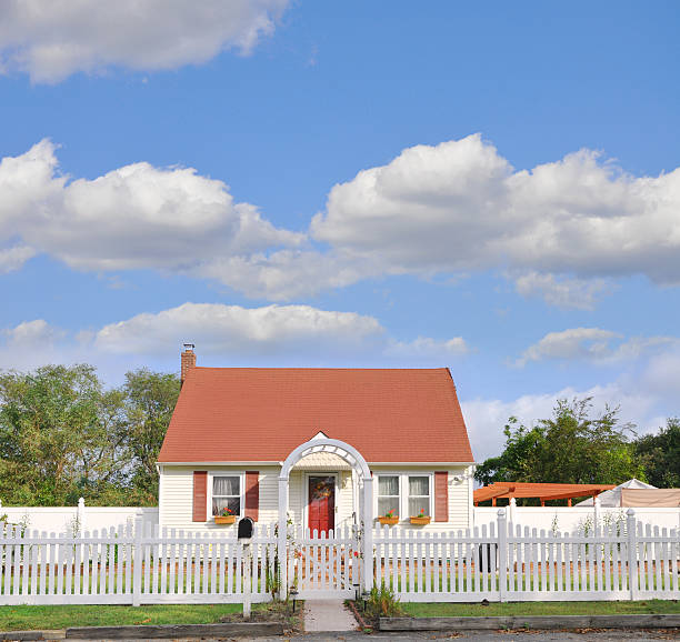 Suburban Bungalow Home White Picket Fence Suburban one story country Bungalow Home White Picket Fence during morning daylight picket fence stock pictures, royalty-free photos & images