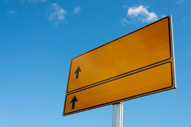 istock Yellow road sign with arrows on sky background. 155551031
