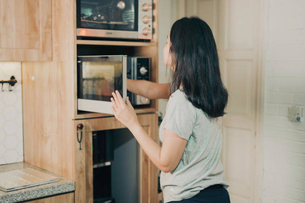istock asian woman cooking using microwave 1555511316