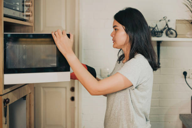 istock asian woman cooking using microwave 1555511317