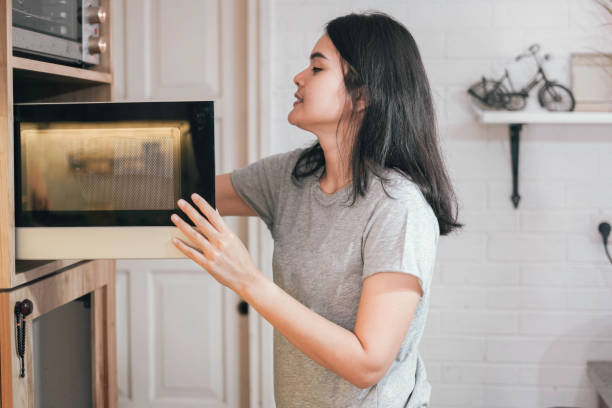 istock asian woman cooking using microwave 1555511864
