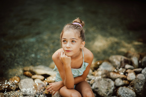 Thoughtful girl in the river
