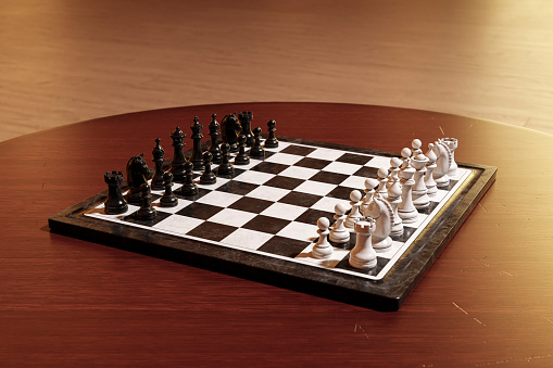 Chess board with figures on a wooden table close-up.