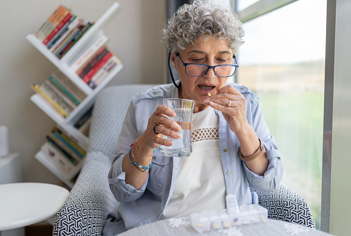 Senior Woman Taking Daily Dosage Of Pill
