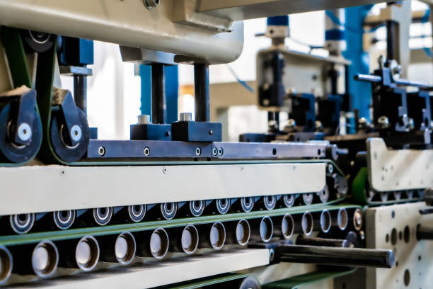 istock A industrial commercial envelope making machine, making paper envelopes for international distribution. Automated engineering machinery for mass production of paper envelopes. 1555551890