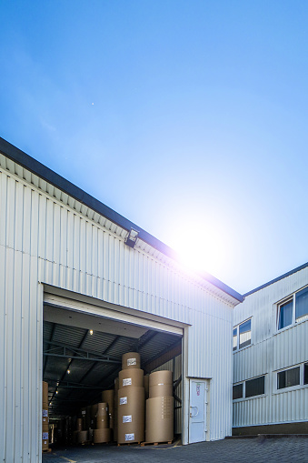 Big production warehouse with paper rolls and printing material