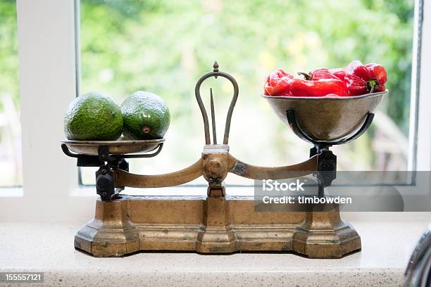 Avacados And Red Peppers On An Antique Kitchen Scales Stock Photo - Download Image Now