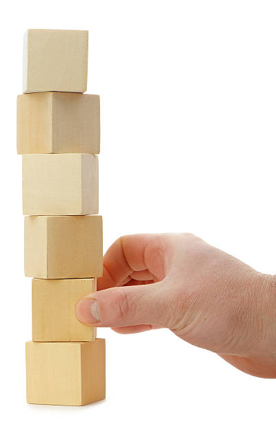 istock The hand establishes a wooden cube. 155557795