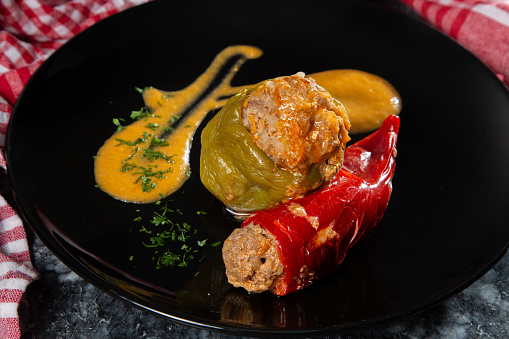 A colorful and oven-baked dish featuring green and red bell peppers