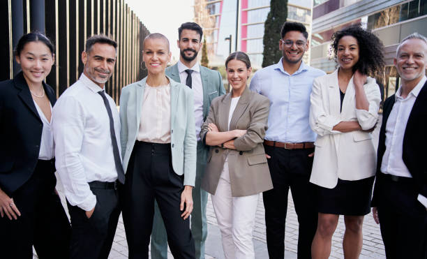 istock Team portrait multi-ethnic professionals smiling posing with confidence. Young and mature colleagues 1555610428