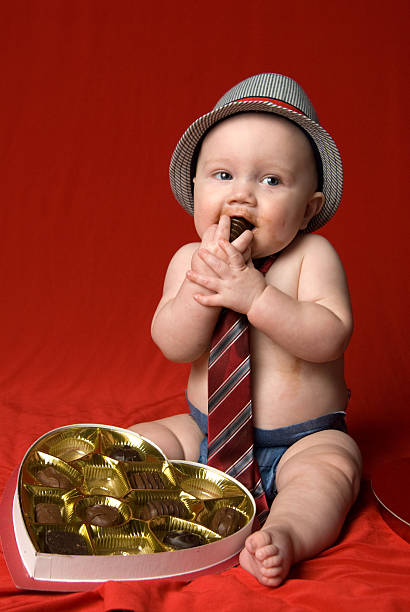 Baby eating chocolate stock photo