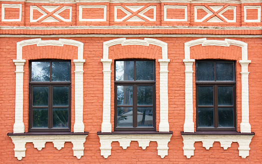 Two closed old windows with wooden shutters