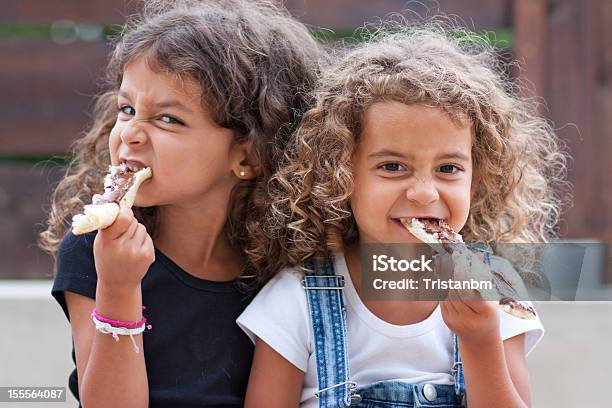 Sisters Eating Stock Photo - Download Image Now - Beautiful People, Beauty, Biting