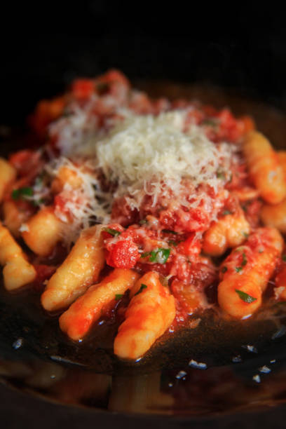 istock gnocchi with tomato sauce and a parmesan cap. 1555655263