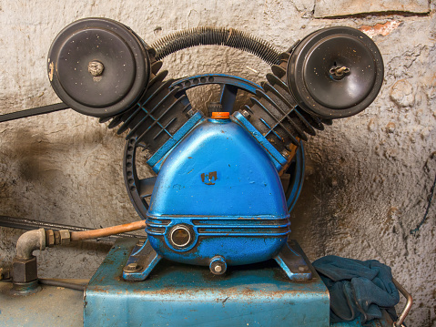 Close-up photography of the very used engine of an air compressor captured in a car shop in the town of Arcabuco, in central Colombia.