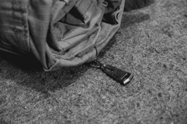 objeto pantalones militares enrollados, y sobre una alfombra áspera. - sweater black close up article fotografías e imágenes de stock