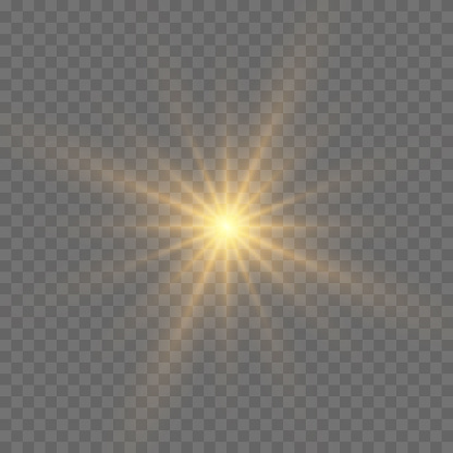 Bright Star. The star burst with brilliance. Yellow glowing light explodes on a transparent background. Golden Light effect. A flash of sunshine with rays. Yellow sun rays.