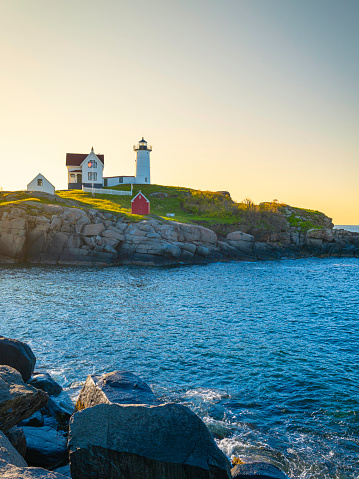 Lighthouse on the coast at sunrise. Nubble Lighthouse on Cape Neddick Nubble island in Maine