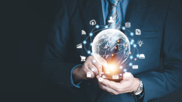 istock Businessman holding virtual world with icons and connection line for data exchange from globalization innovation technology and global business concept. 1555687834