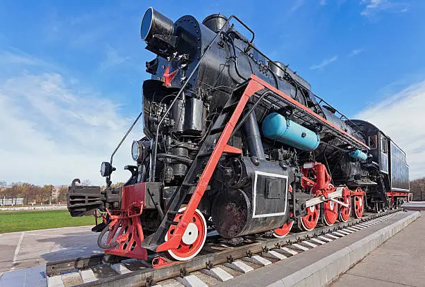 Old steam locomotive with the red star over blue sky