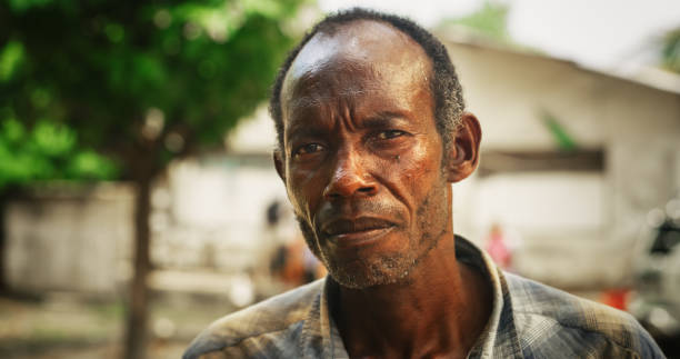 Cap-Haitien, Haiti - February 4th, 2010 : A Haitian man sits on a side of the street, after being rendered homeless by the earthquake that destroyed his house and millions of other structures and lives in Haiti.