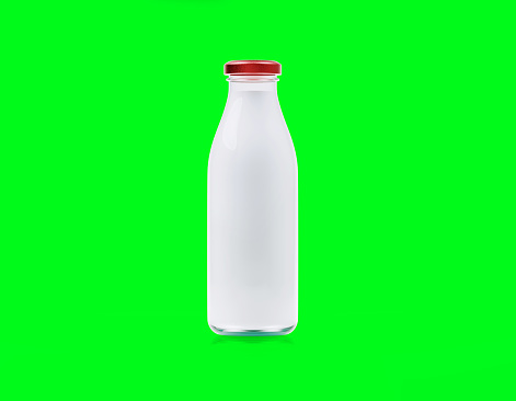 White glass milk bottle on green background. Horizontal composition.