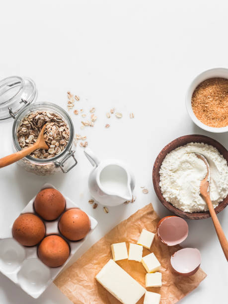 istock Ingredients baking background - oat flakes, flour, cane sugar, butter, eggs on a light background, top view 1555695280