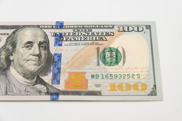 istock 100 dollar bill close-up isolated on white background 1555711953