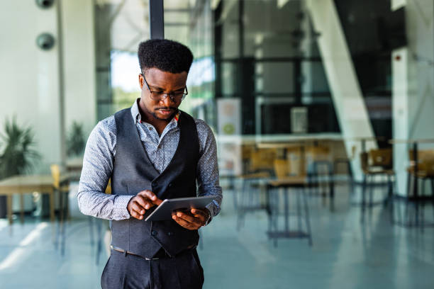 istock African-American businessman using digital tablet 1555729025