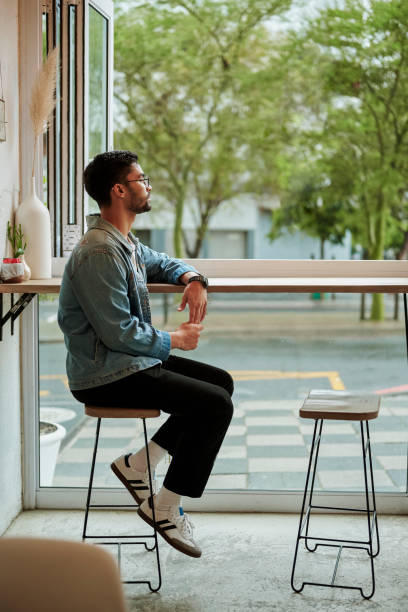 Young man waiting to meet his date in a cafe